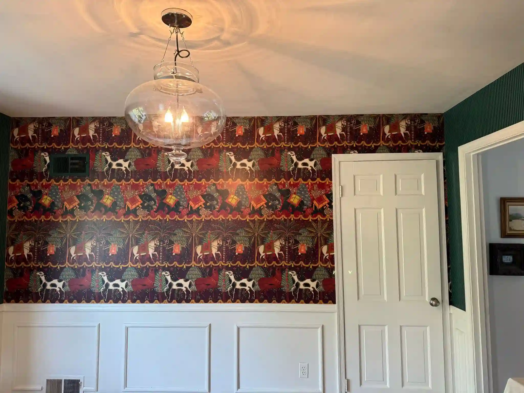 Soft botanical motifs repeated across a light-colored wall