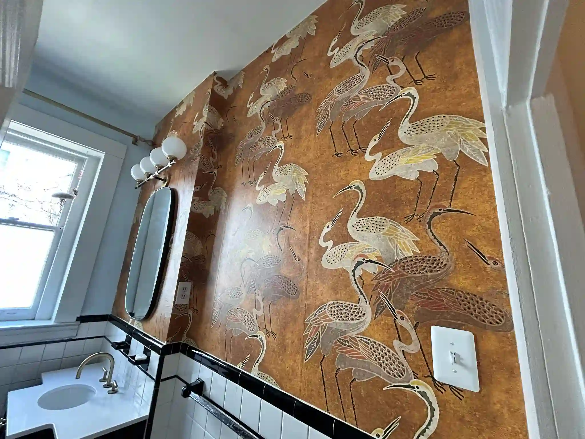 A small room with a statement wallpaper pattern on the wall